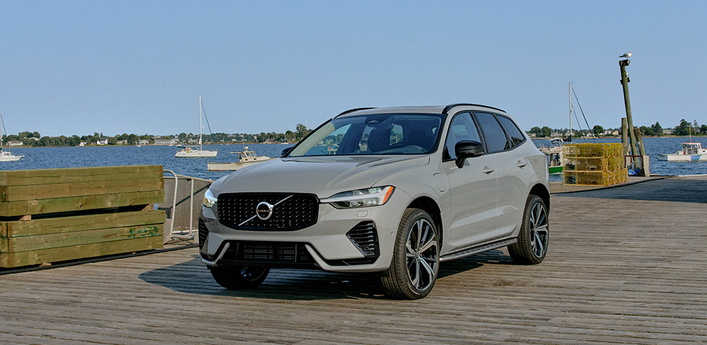 Grey Volvo XC60 plug-in hybrid is parked on a fishing dock